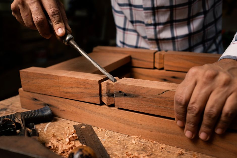 Master woodworker crafting handmade furniture in a professional workshop